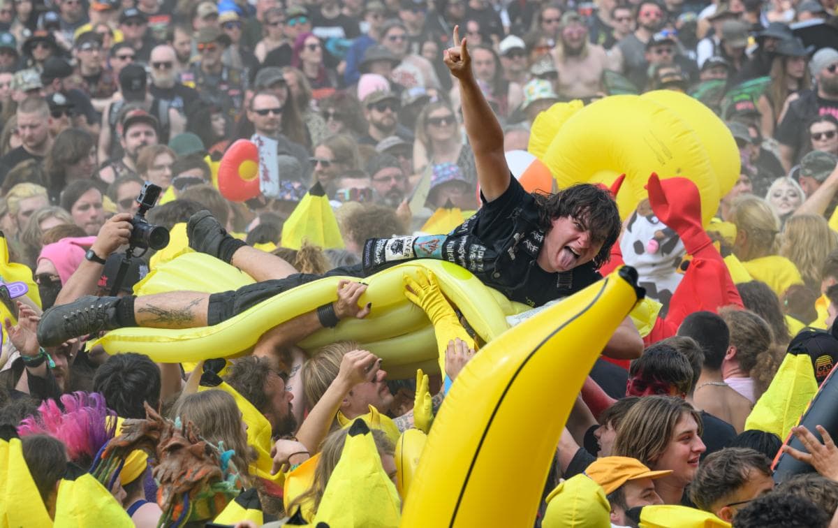 Crowd surfer riding an inflatable banana over the crowd at Bloodstock Open Air, Catton Park
