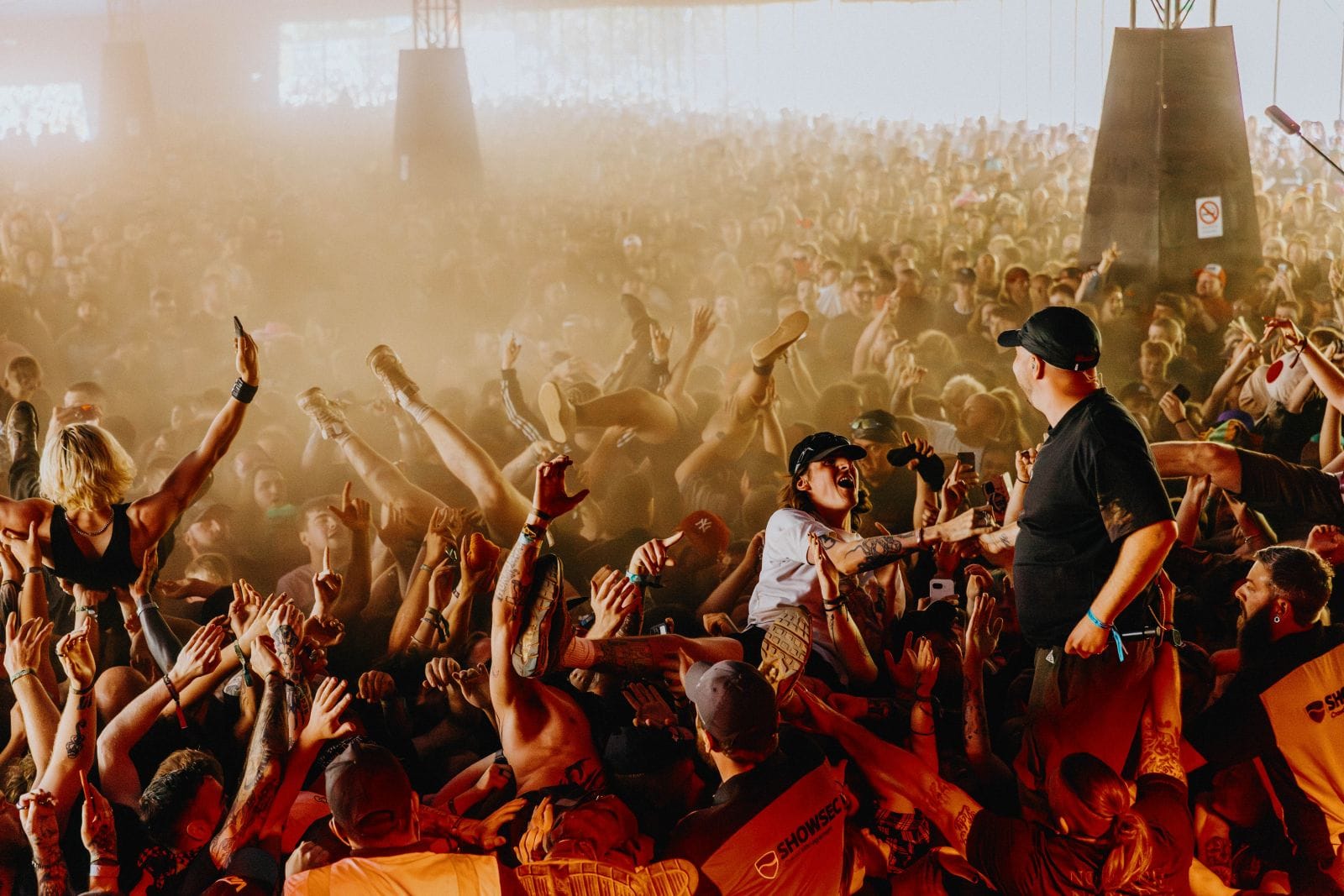 Crowd surfers pouring over the barrier at Download Festival 2025, Donington Park